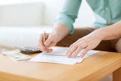 close-up-man-counting-money-making-notes-savings-finances-economy-home-concept-calculator-home-46486285
